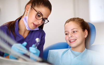 Dentist in Bendigo explaining fissure sealant procedure to a child