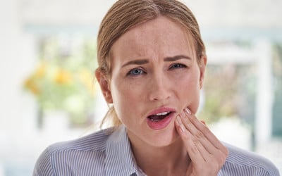 Lady with toothache waiting to see emergency dentist