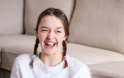 Nervous teenager is laughing after having dental happy gas treatment