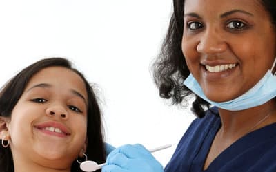 Happy child and dentist in bendigo after the fluoride treatment